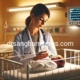 Neonatologist feeding a premature baby in a hospital crib using a bottle symbolising neonatal nutrition